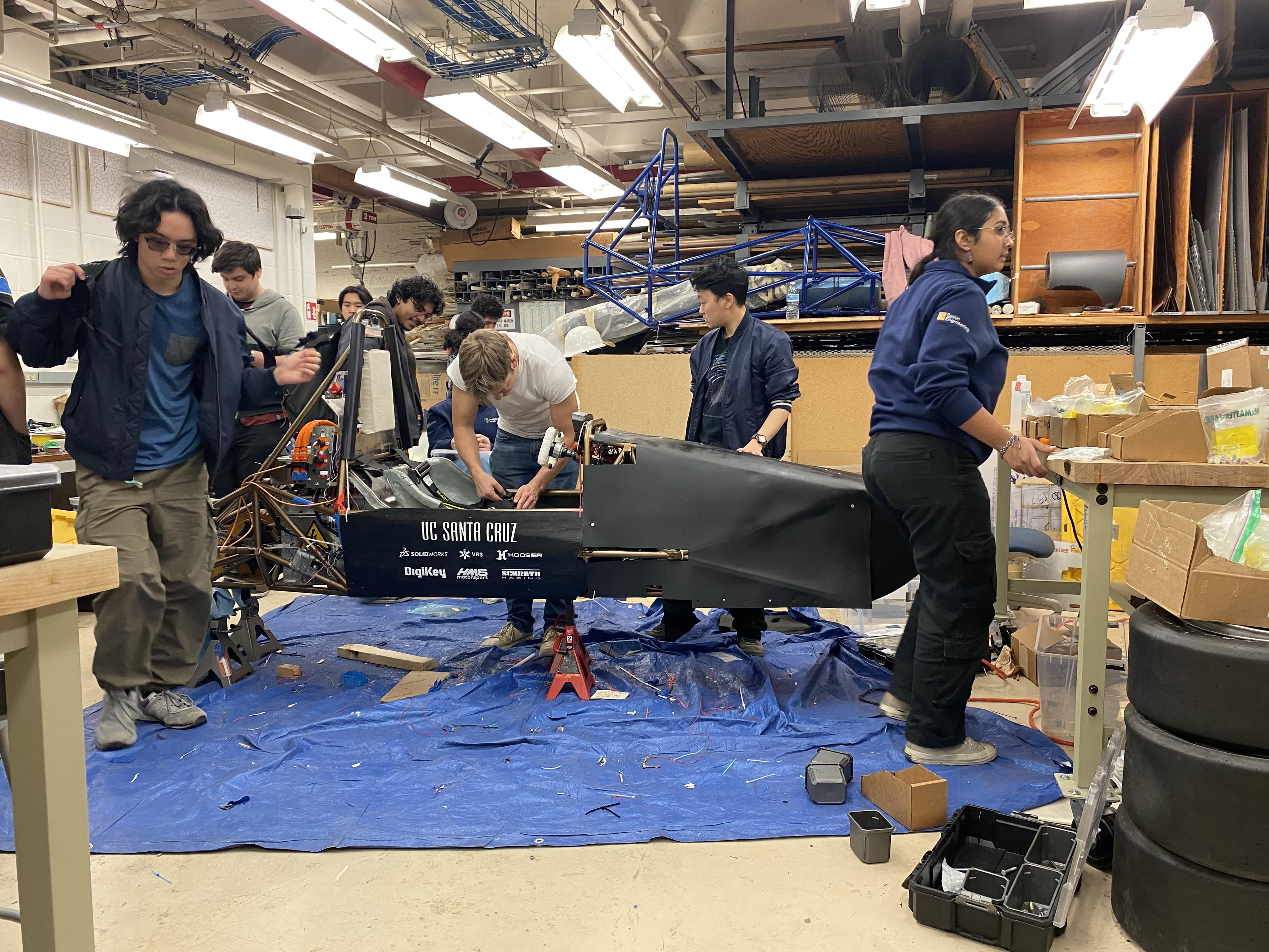 Team Members Work Together to Help Get the Car Ready For Competetion